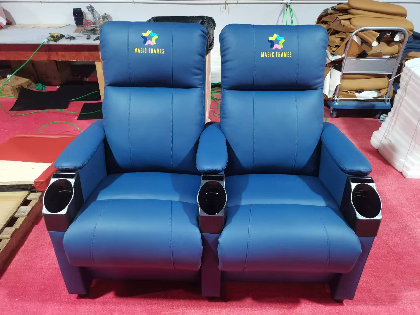Blue upholstered cinema loveseat with cup holders
