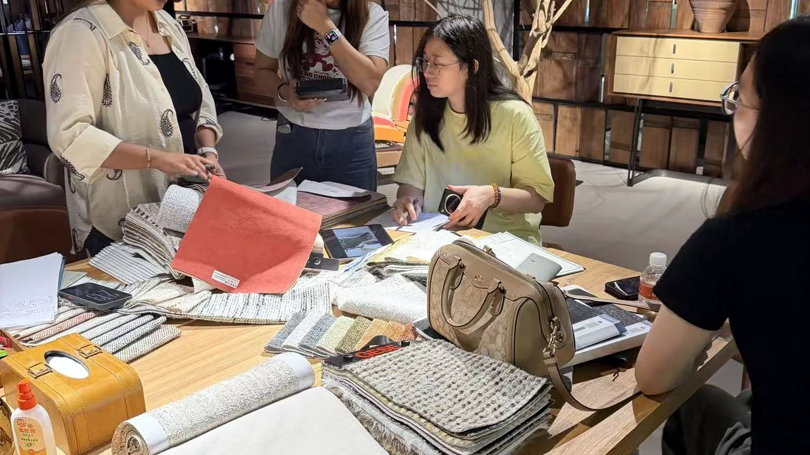 Furniture fabric and finish samples being reviewed in a Foshan showroom
